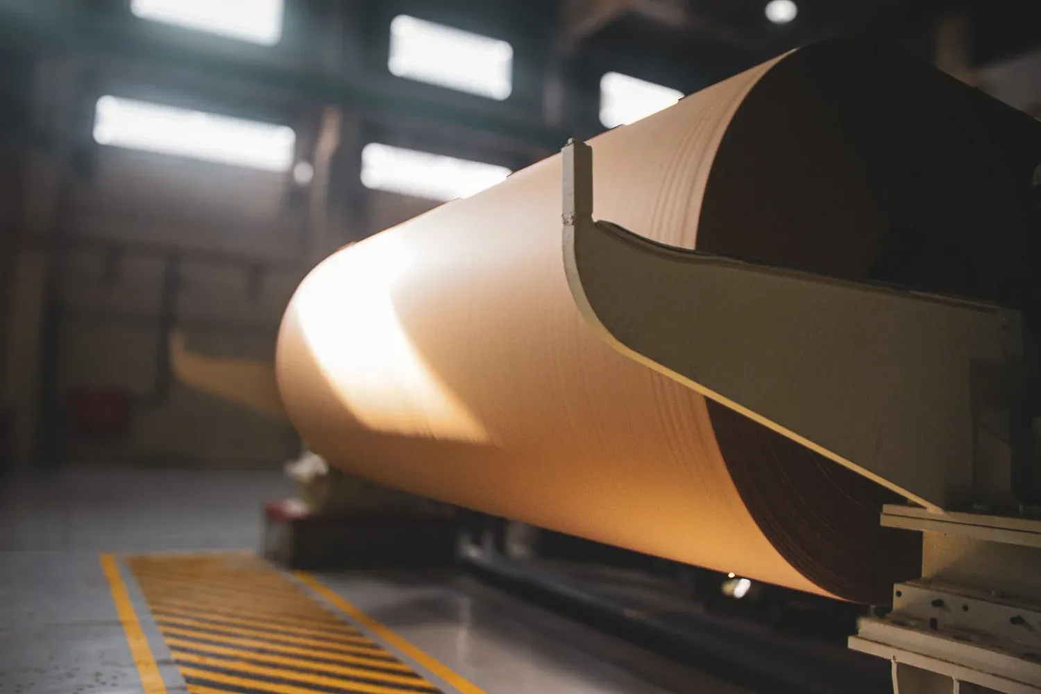 Brown paper sheet passing over the winding equipment