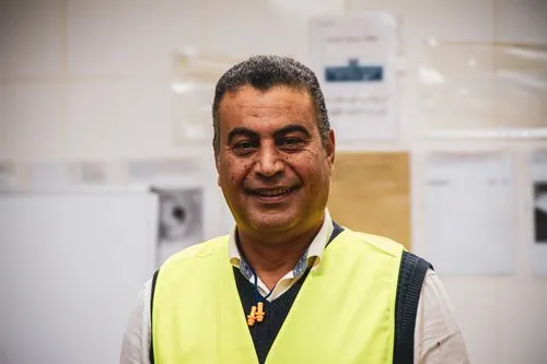 Smiling mill team member in a reflective vest