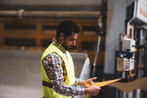 Mill team member examining a paper sample