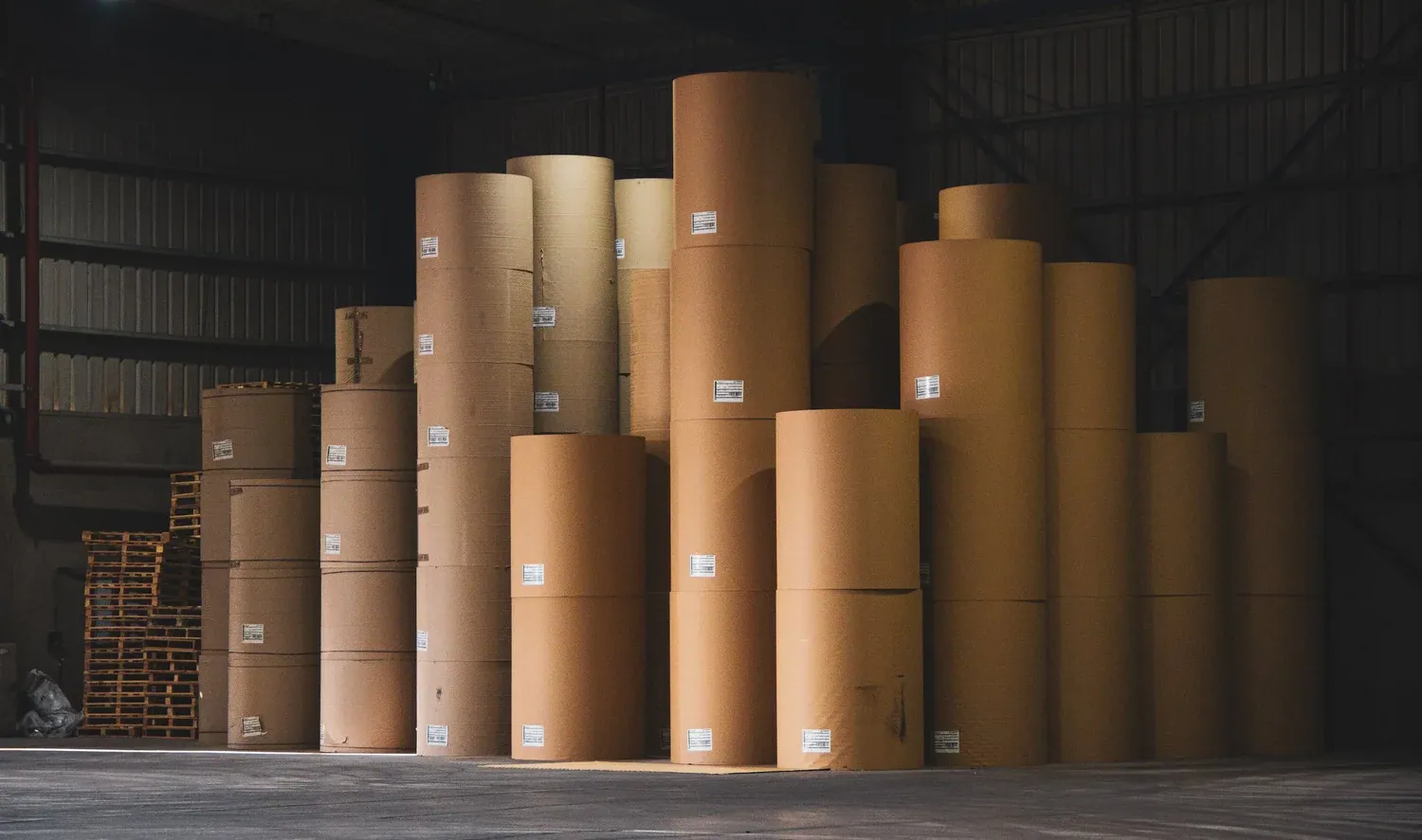Brown paper rolls stacked upright in the Interpac warehouse
